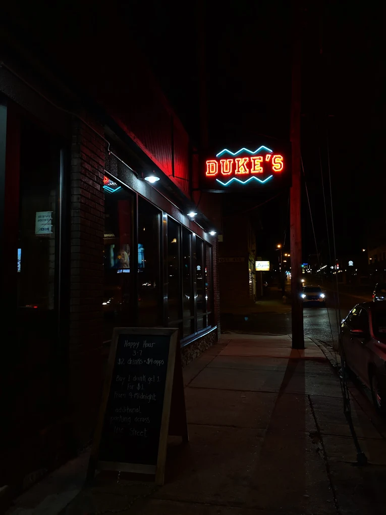 Duke's exterior at night with neon sign glowing